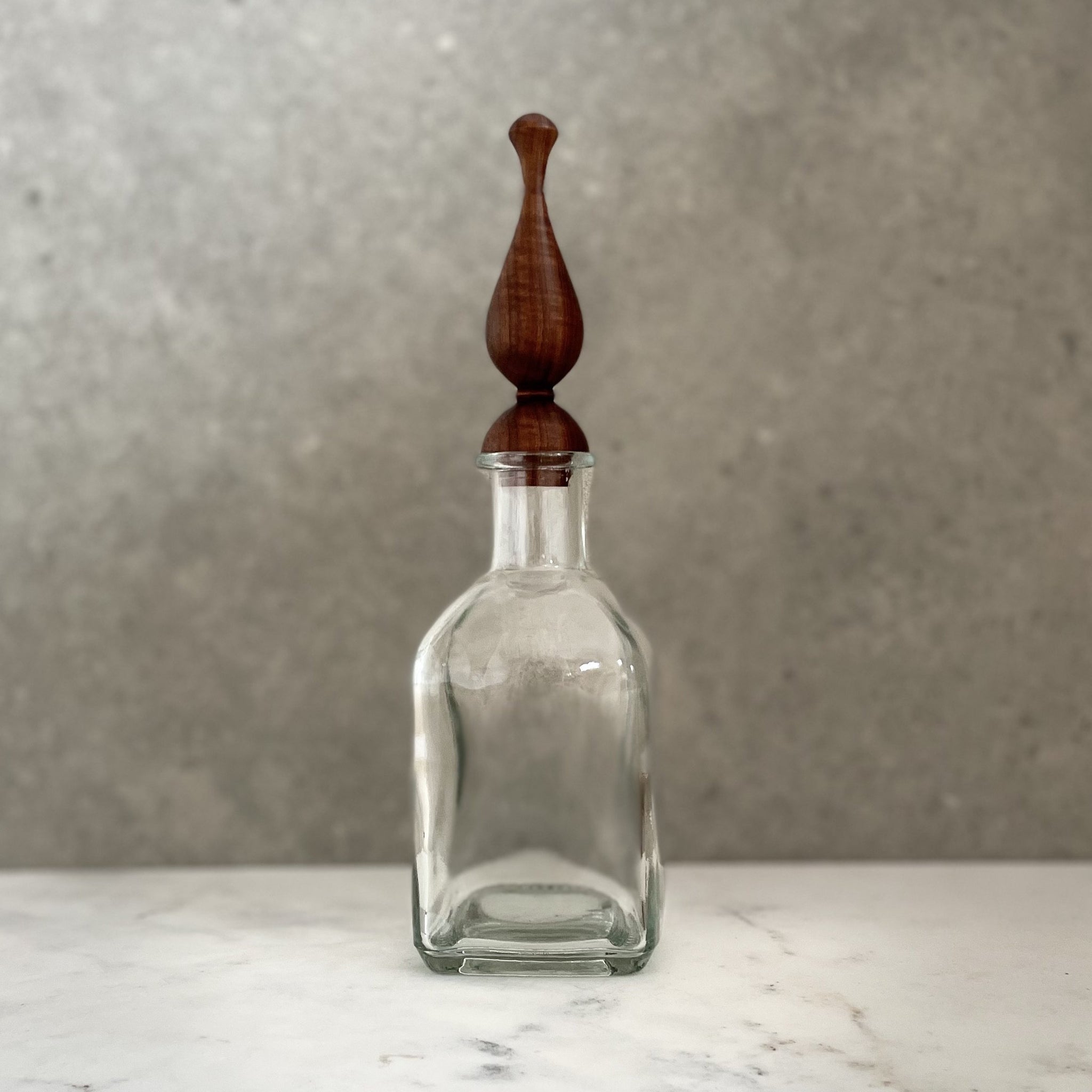 Glass bottle with bespoke handcrafted wooden stopper
